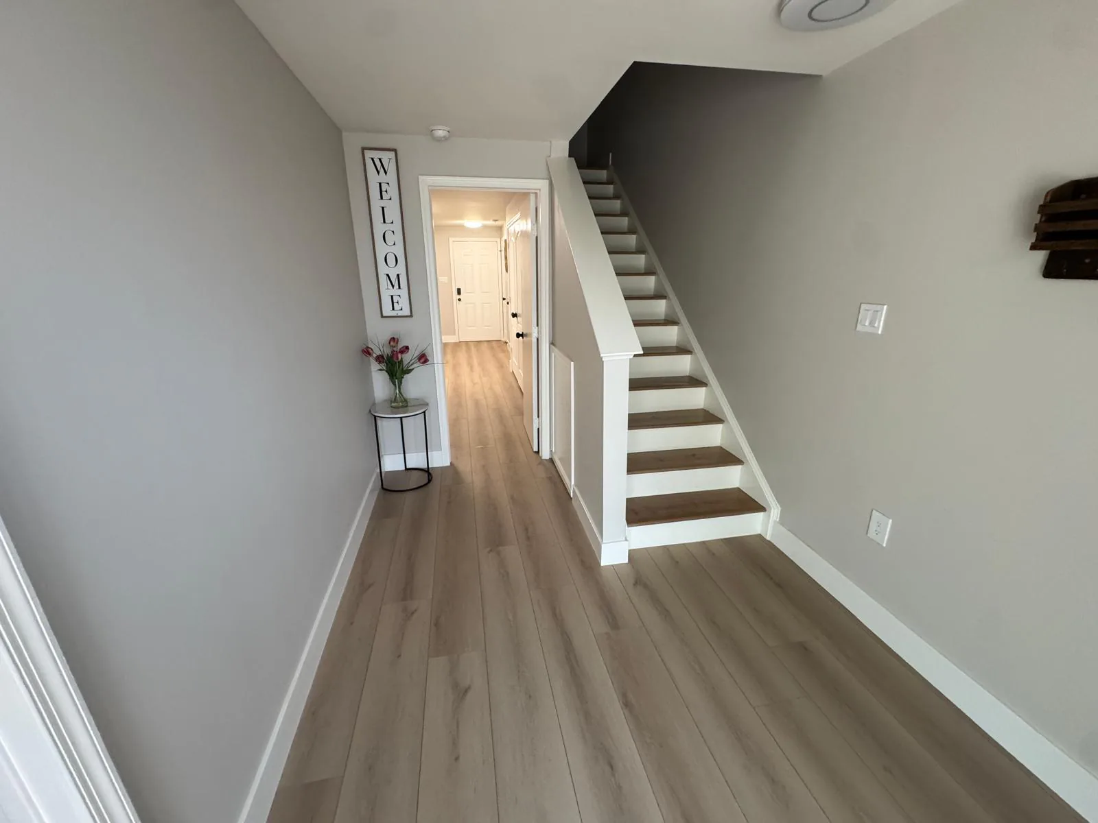 Completed hallway and staircase after painting and flooring work
